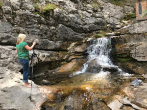 Amy photographing a waterfall